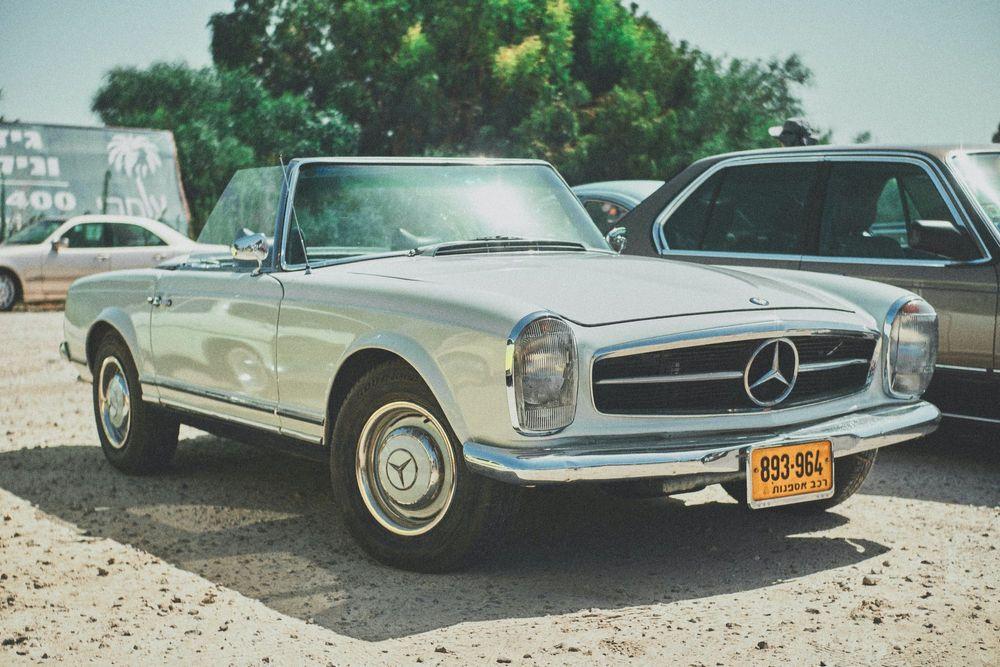 Classic Mercedes on a dirt car lot.