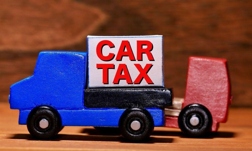 Car tax on top of a blue wooden car