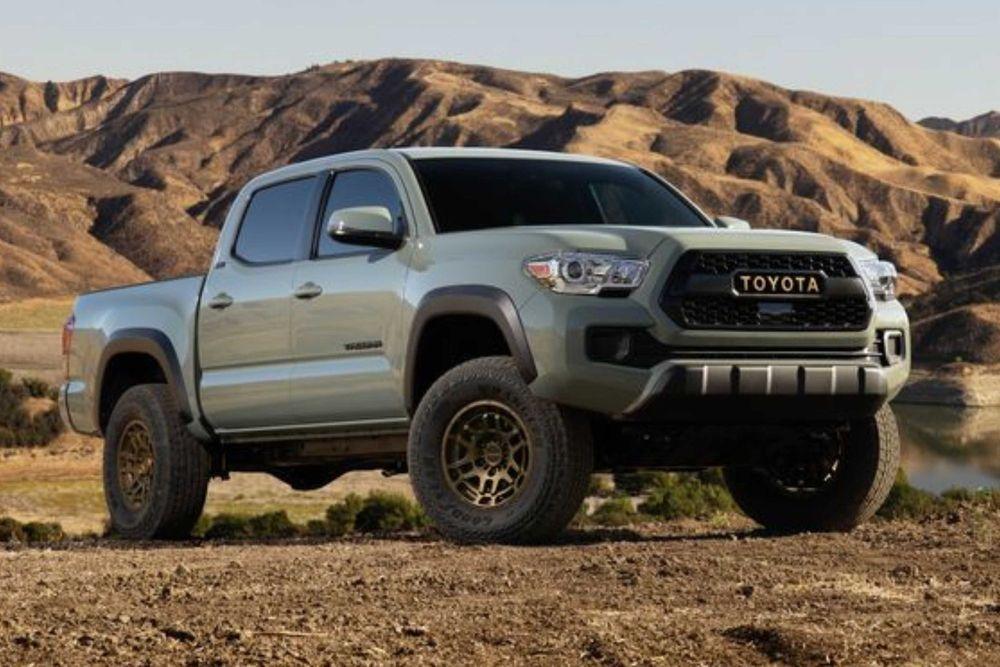 Tan 2022 Toyota Tacoma on dirt road