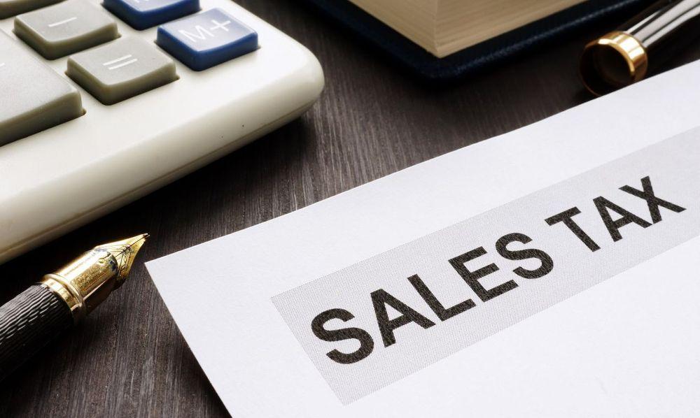 Sales tax paper on an office desk next to a pen