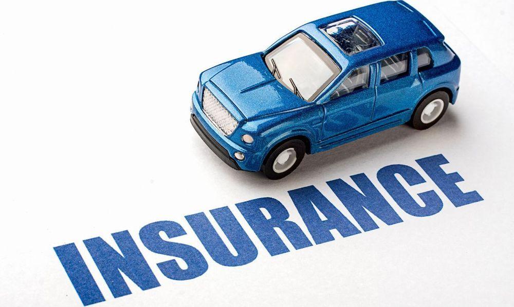 Blue toy car over the word insurance