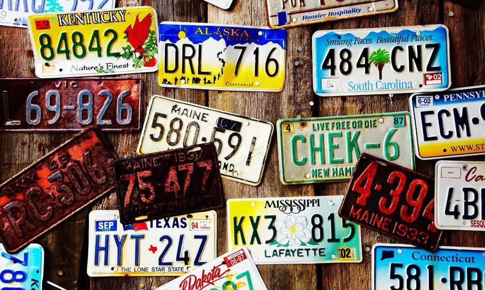 Wooden wall with license plates on it