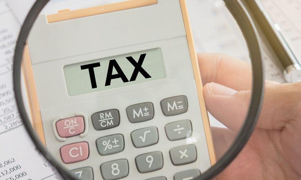 Closeup tax on calculator, concept of tax return, taxation, tax refund, tax preparation.