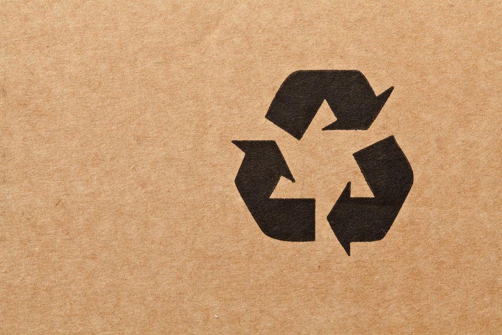 Black recycle symbol on a cardboard box