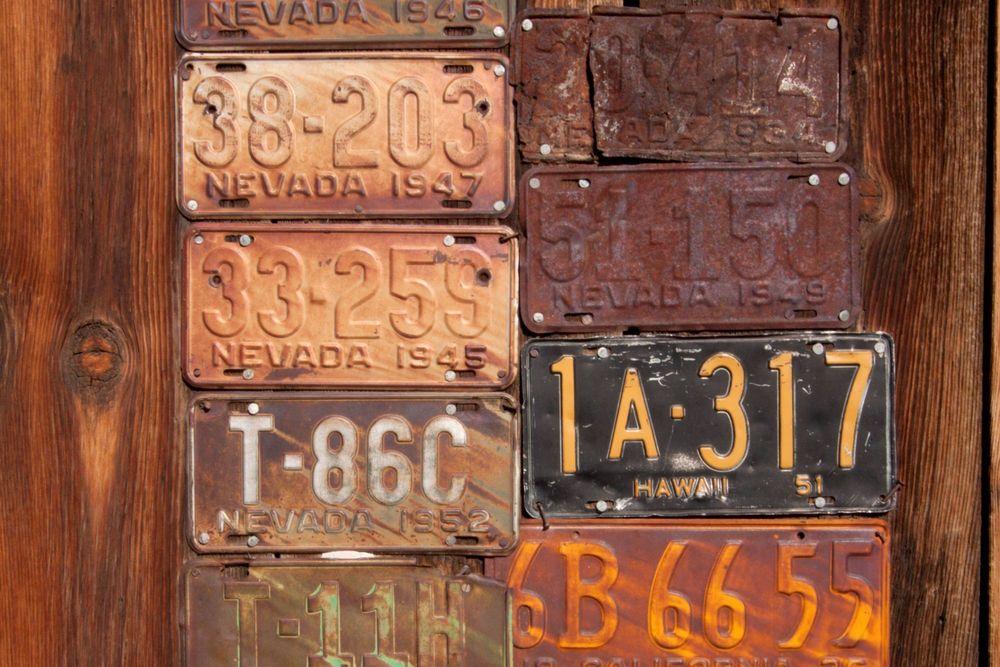 Rusty license plates on a wood background