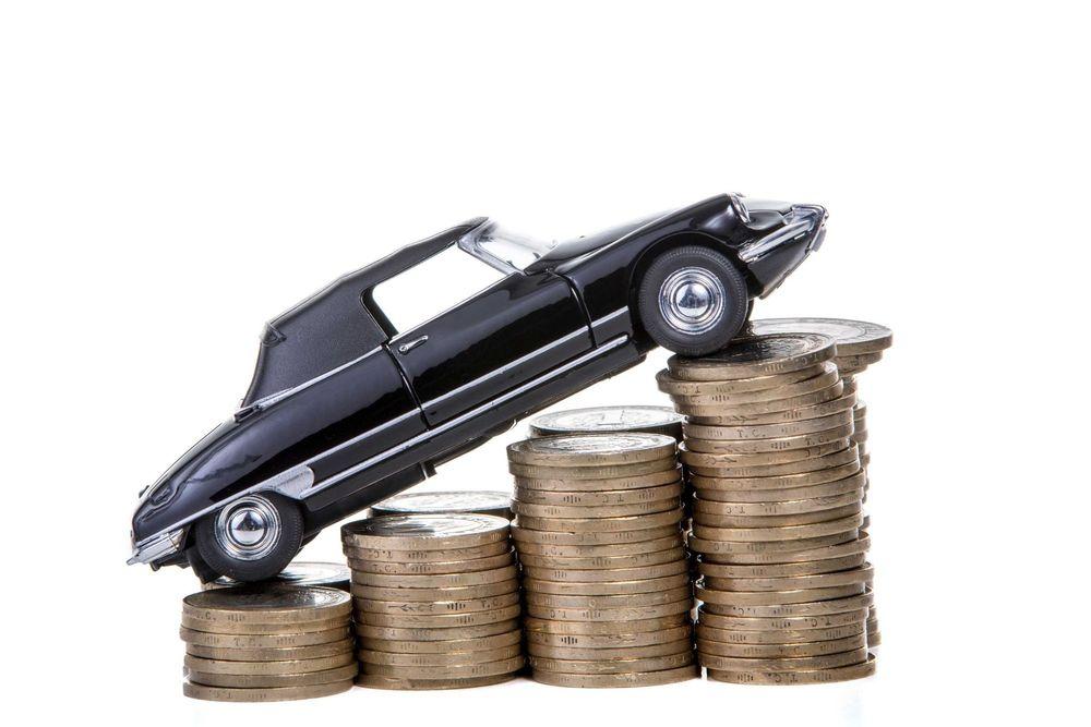 Toy car on top of multiple stacks of coins