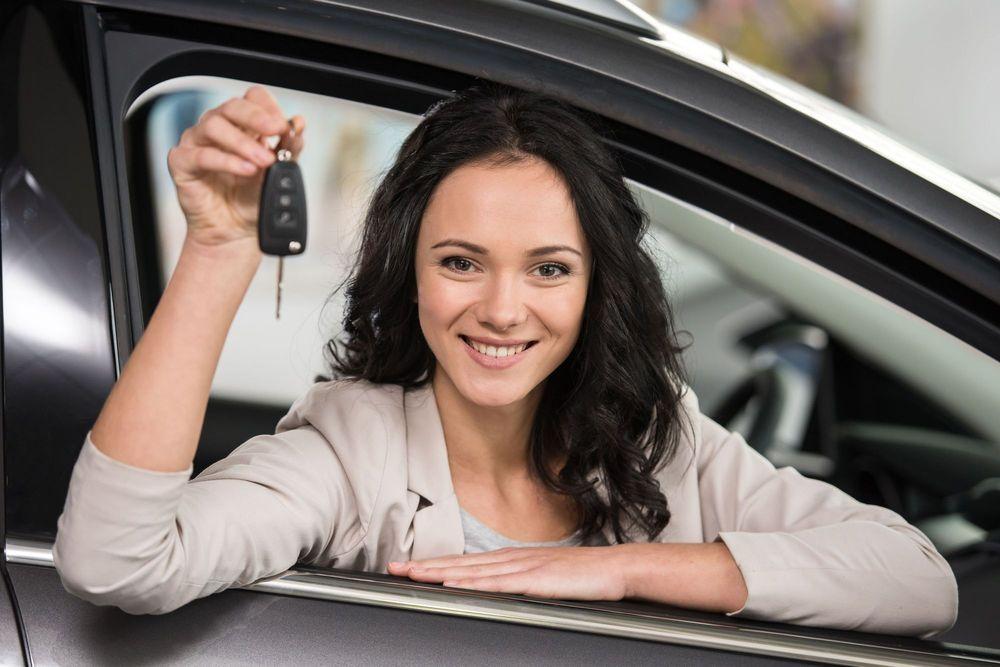 Woman holding the keys to a car
