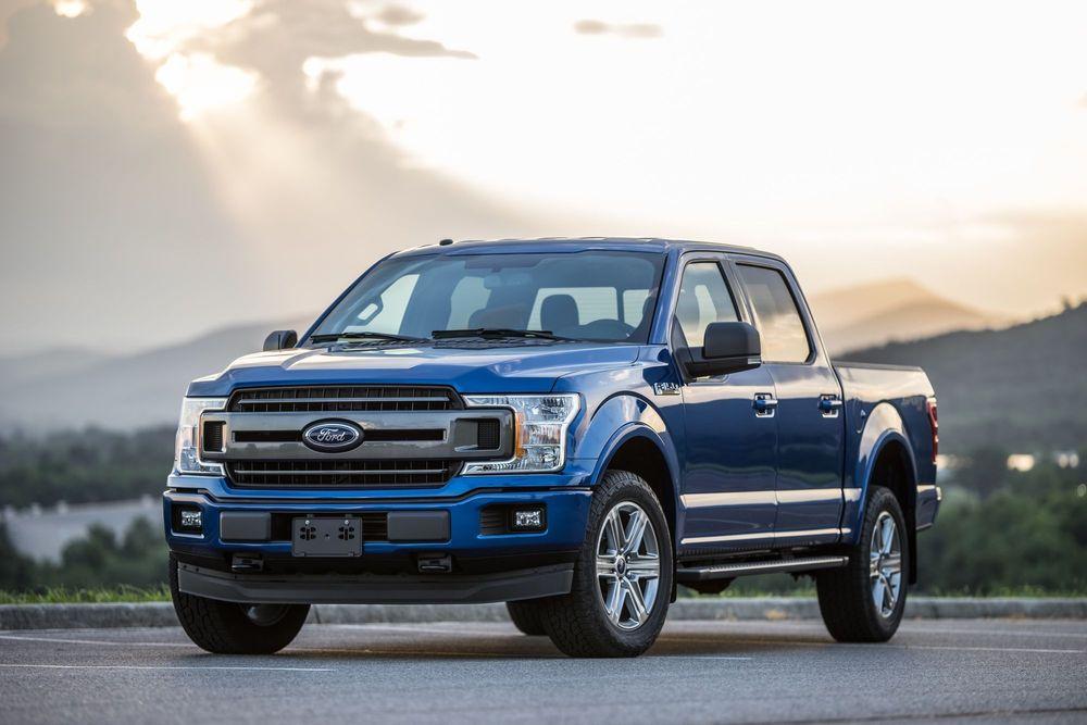 Blue Ford F-150 parked in parking lot.