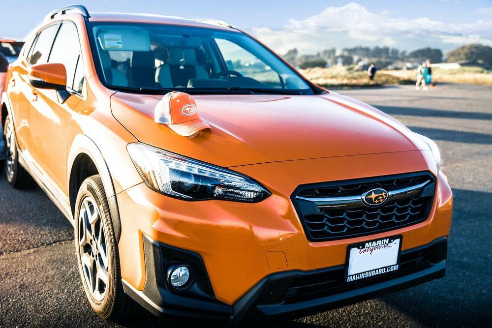 Orange Subaru Crosstrek parked in a parking lot.