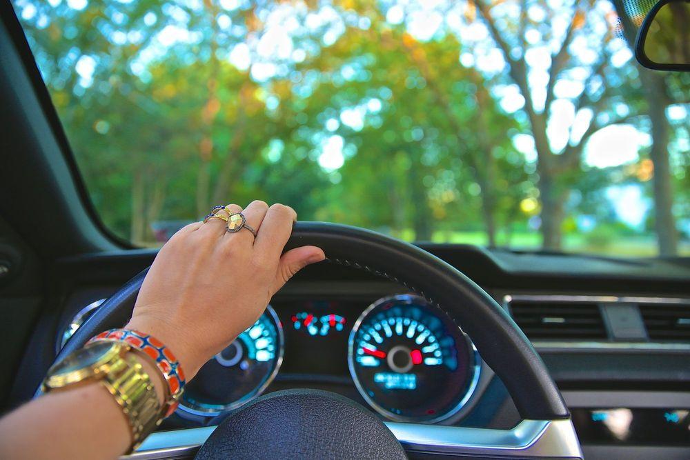 Woman with jewelry on driving a car.