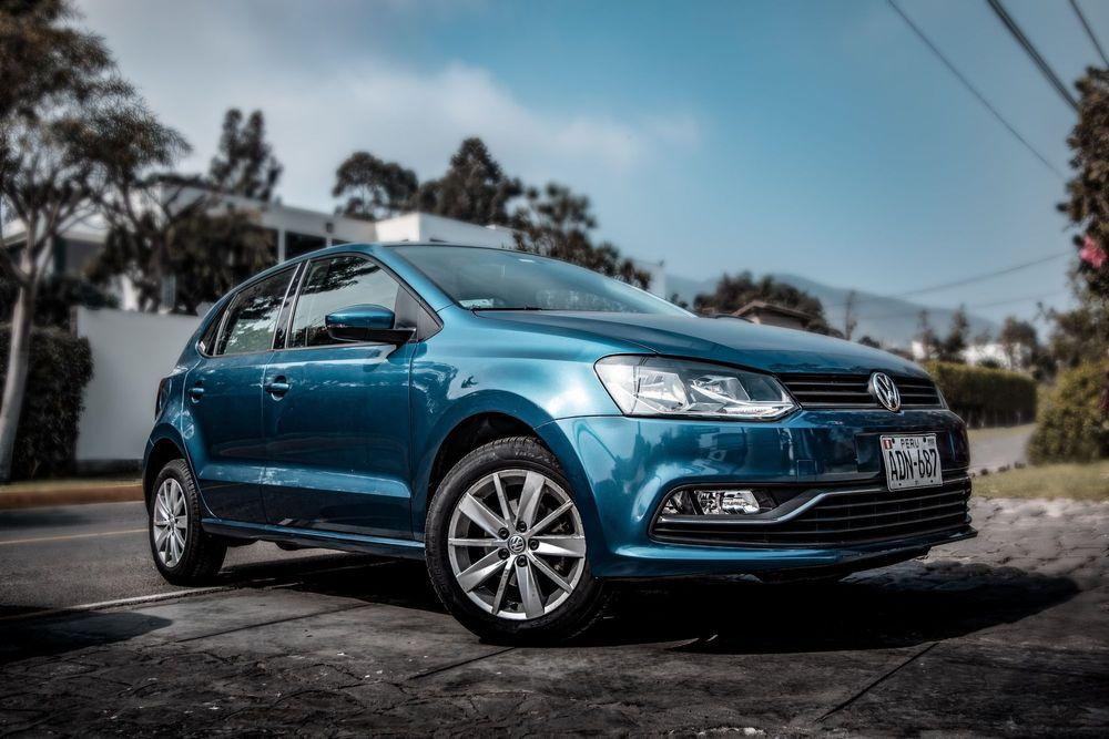 Blue Volkswagen parked in driveway.