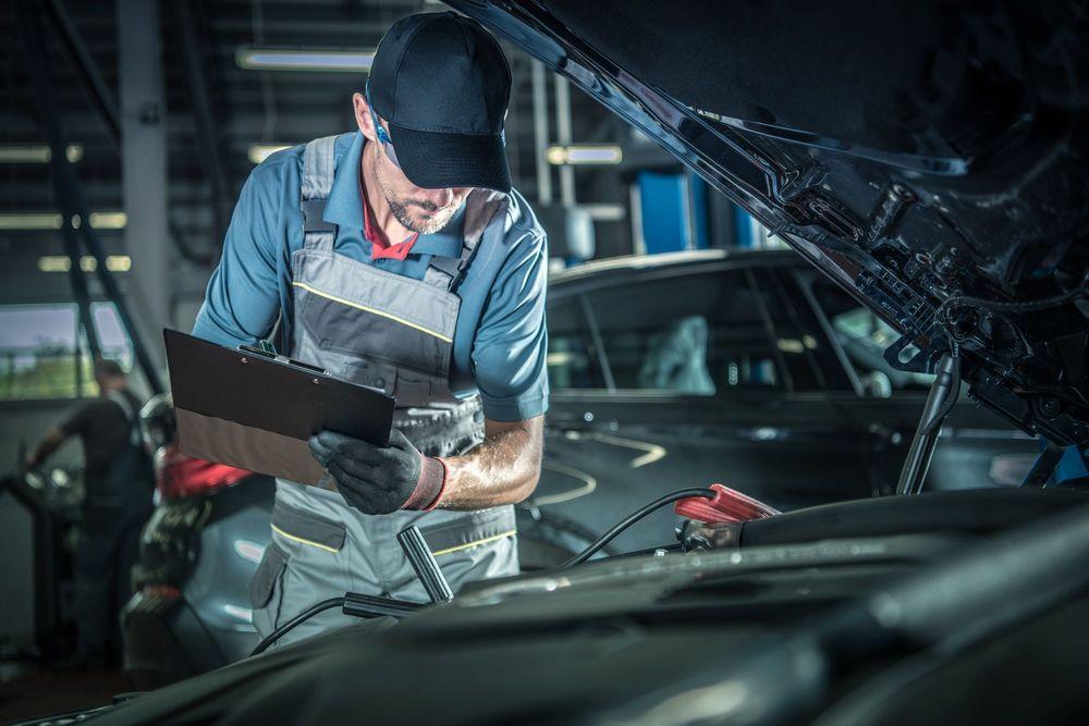 Auto mechanic performing a vehicle inspection.