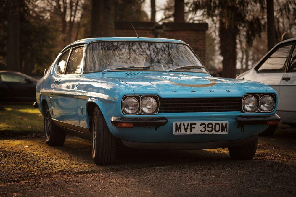 Blue classic coupe parked.