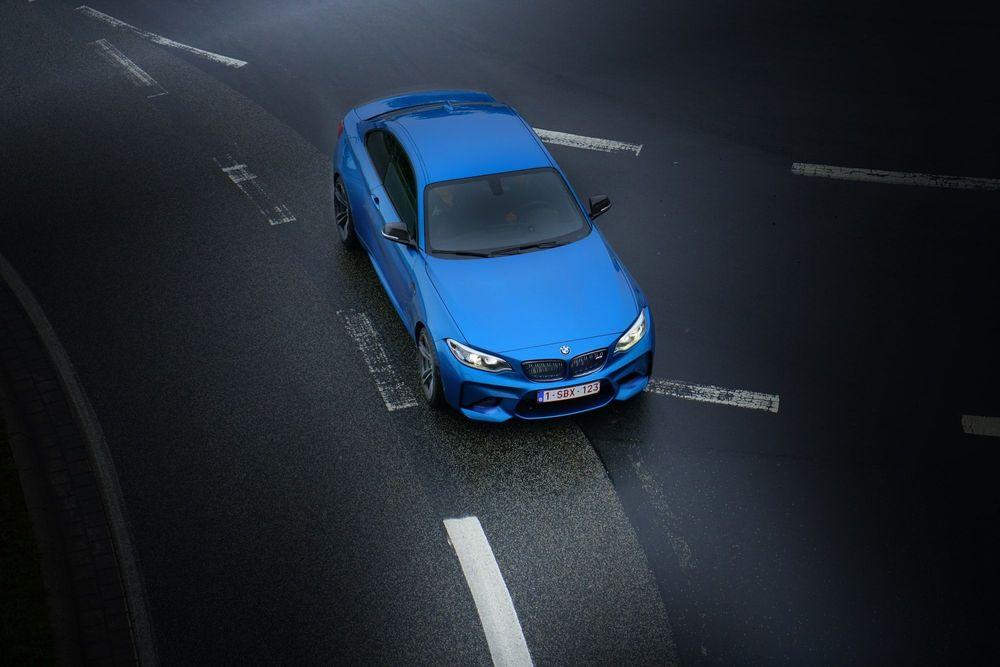 Blue car driving off the Edmunds used car lot