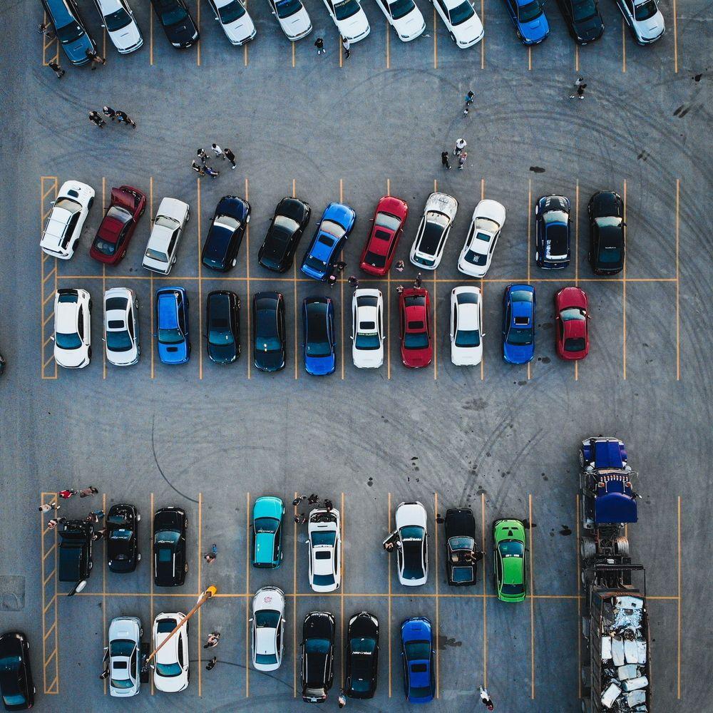 Top-down drone shot of a car dealership lot