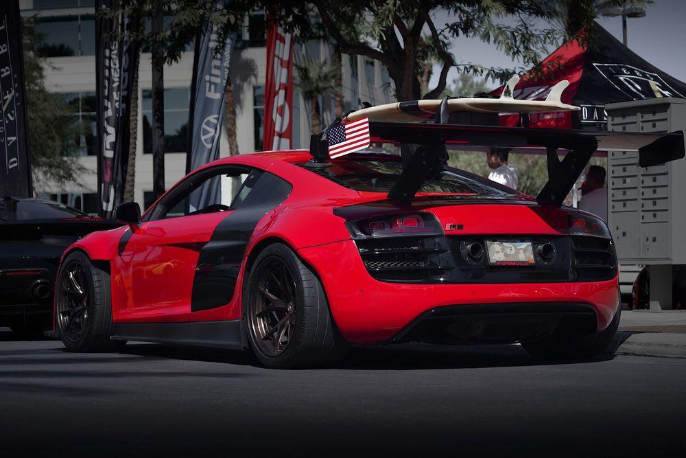 Custom red car with American flag spoiler.