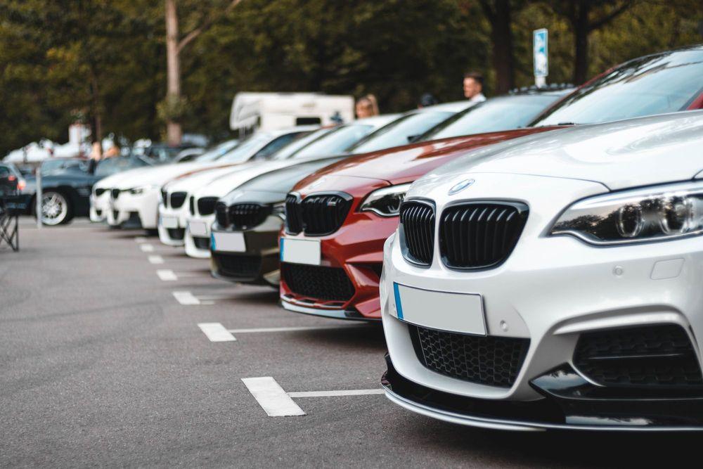 Front of BMW cars parked in car lot.