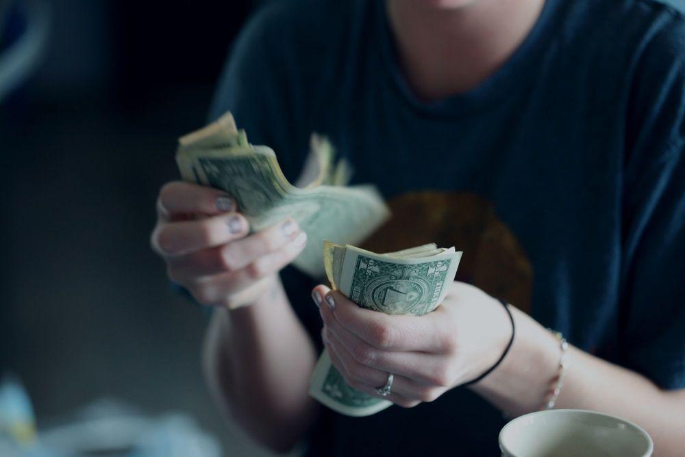 Person counting cash.