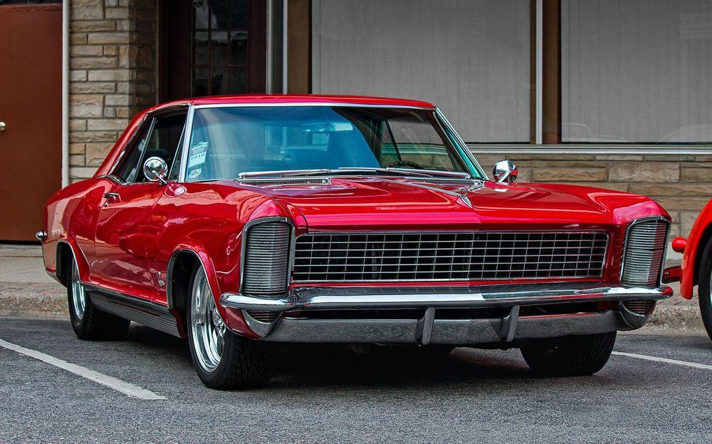 Red classic car parking in a parking lot